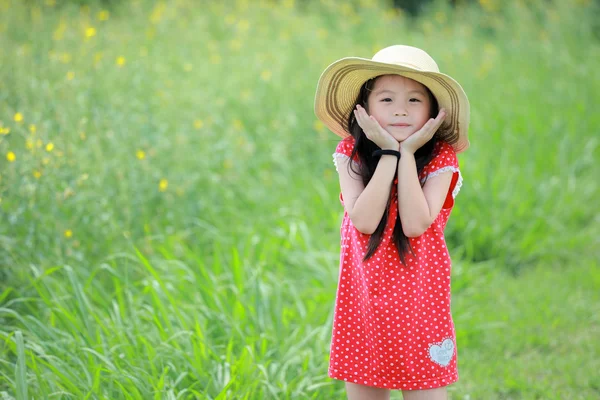 Portrait of beautiful happy little girl in a field of yellow flo — Stock Photo, Image