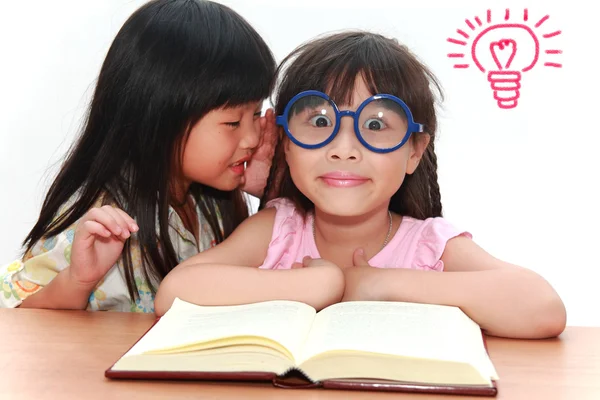 Cute little asian girl whispering something to her sister — Stock Photo, Image