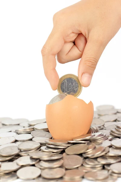 Hand keep euro coin on broken eggshell — Stock Photo, Image