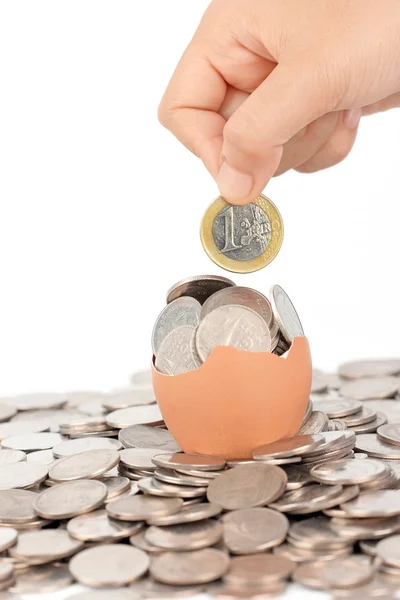 Hand keep euro coin on broken eggshell — Stock Photo, Image