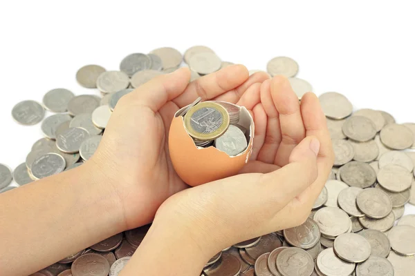 Hands holding eggshell with euro coins — Stock Photo, Image