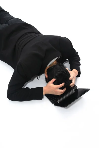 Businessman depressed put his head on the laptop. — Stock Photo, Image