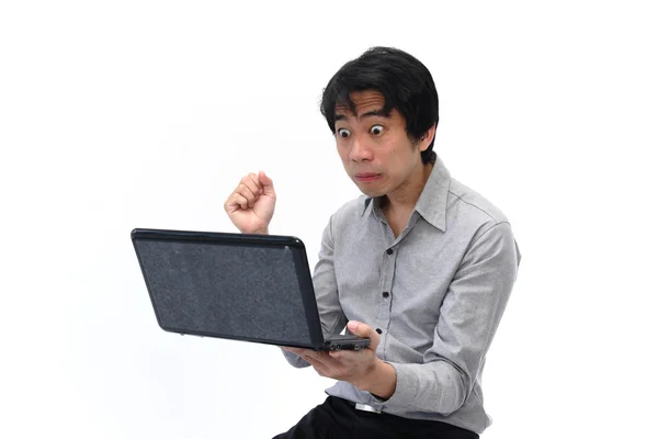 Businessman under stress while looking at laptop — Stock Photo, Image