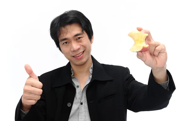 Businessman showing thumbs up gesture with apple — Stock Photo, Image