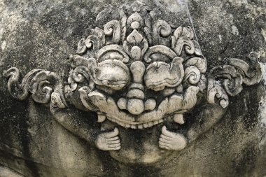 Stone giant head thai style in chet yot temple, Chiang Mai Thailand. clipart