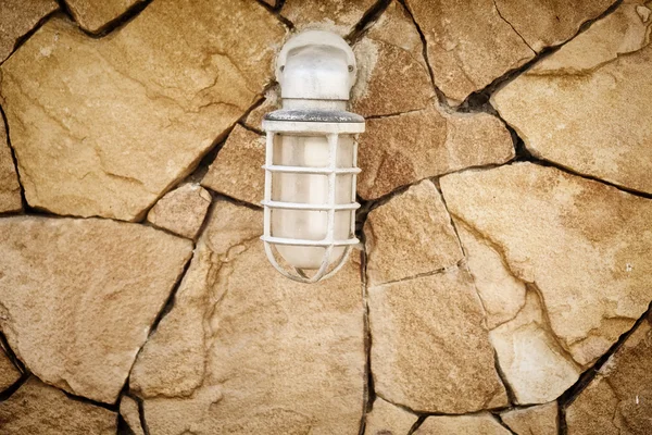 Lamp on stone wall — Stock Photo, Image