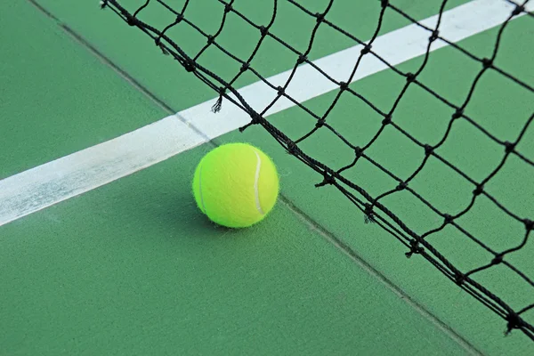 Tennis ball in net — Stock Photo, Image