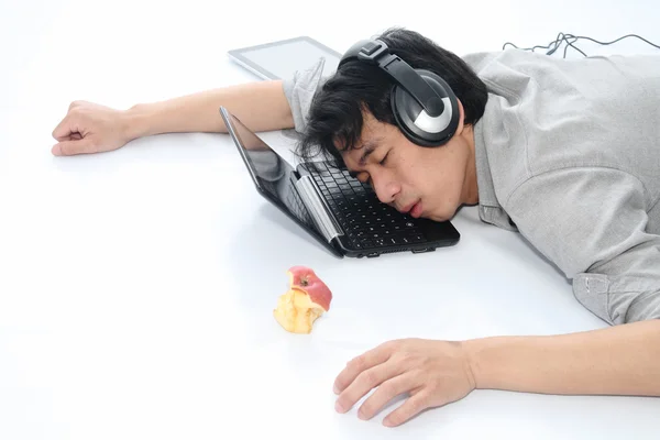 Businessman sleeping in office on laptop — Stock Photo, Image