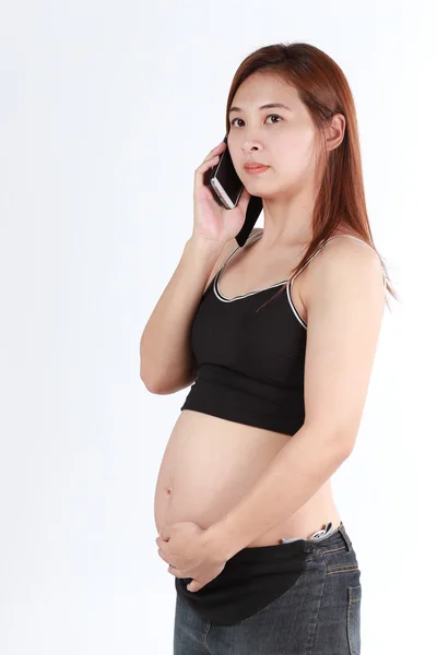 Beautiful Asian pregnant woman using phone isolated white backgr — Stock Photo, Image