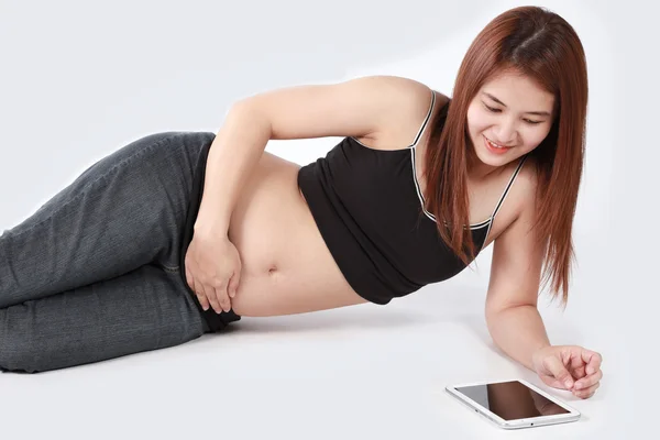 Beautiful Asian pregnant woman using tablet computer isolated wh — Stock Photo, Image