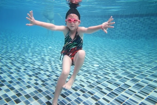 Gadis asia kecil di bawah air di kolam renang — Stok Foto