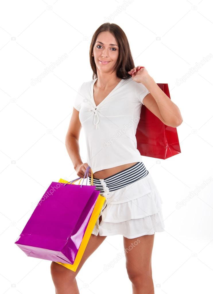 Side view of woman holding shopping bags against