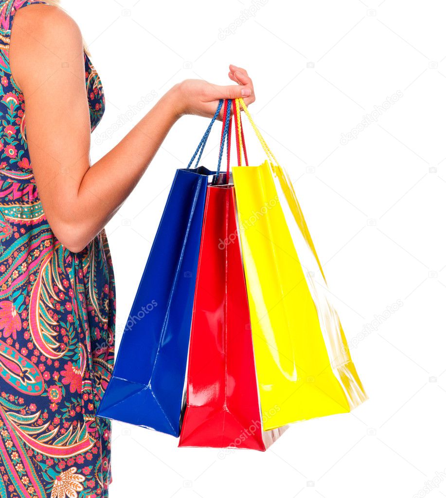 Shopping bags set in woman's hand isolated on white