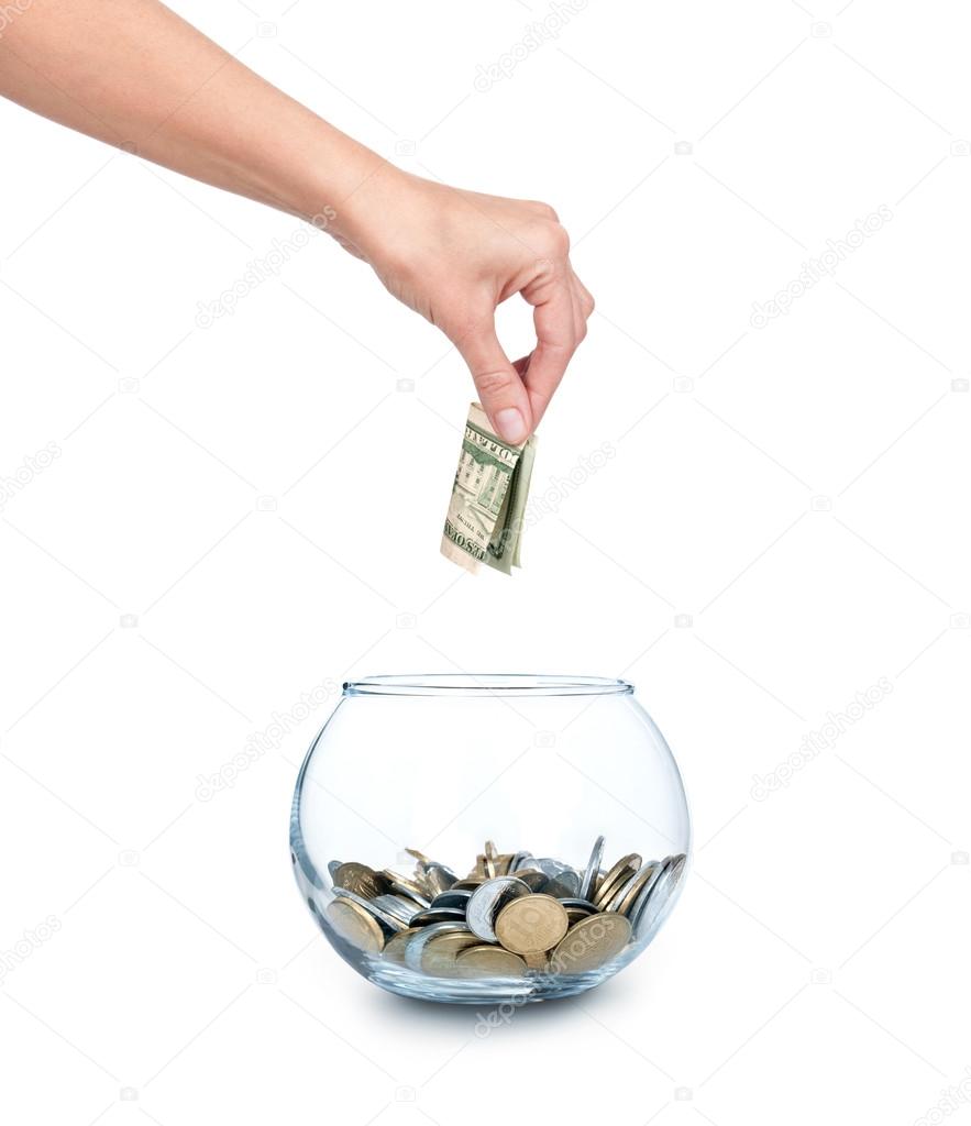 Glass bank for tips with money and hand isolated on white. Ukrainian coins