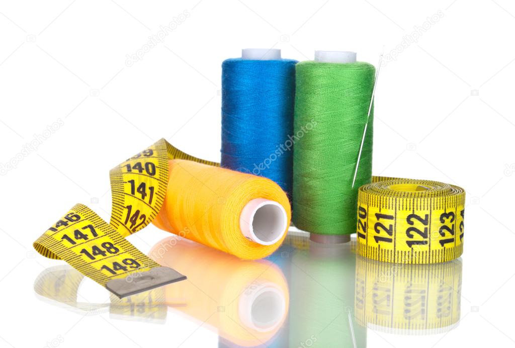 Bright bobbin thread and tape measuring isolated on white