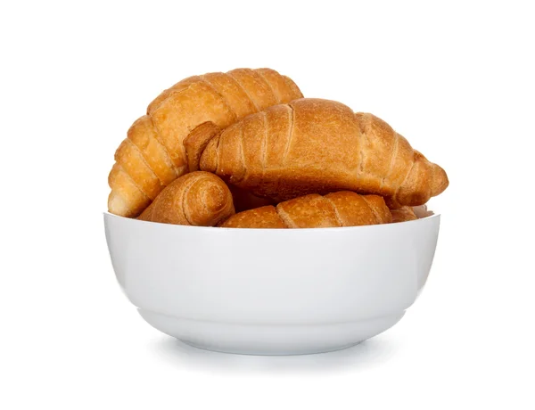 Croissants op plaat geïsoleerd op witte achtergrond — Stockfoto