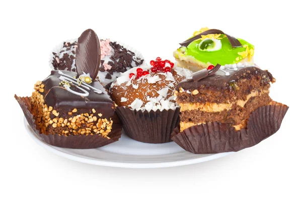 Beautiful tasty chocolate cakes, cupcaks and fruit cake on plate isolated on white — Stock Photo, Image