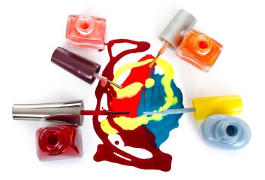 Bottles with spilled nail polish over white background clipart