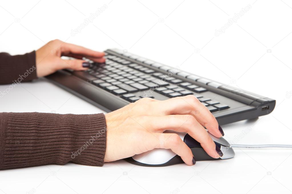 Hands typing on the computer keyboard, computer mouse on a white background