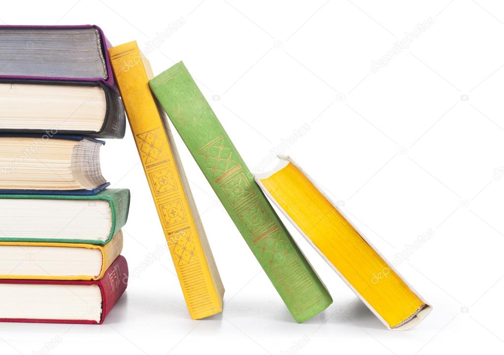 Stacked old colorful books on white background