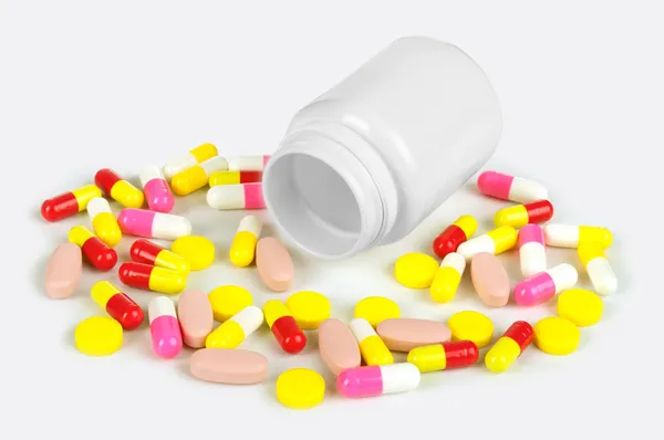 Pills from bottle on the white — Stock Photo, Image