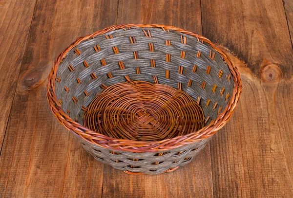 Empty basket isolated on wooden background — Stock Photo, Image