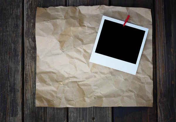 Blank retro photo frame over crumpled paper — Stock Photo, Image