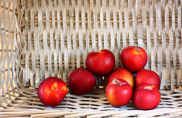 Apples in a basket on a wooden background — Stock Photo, Image