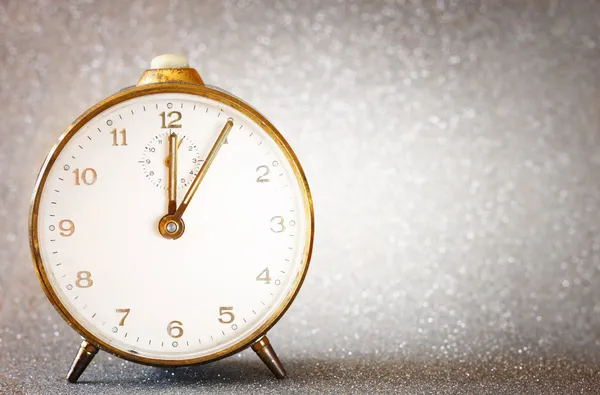 Vintage clock with glittering silver background — Stock Photo, Image