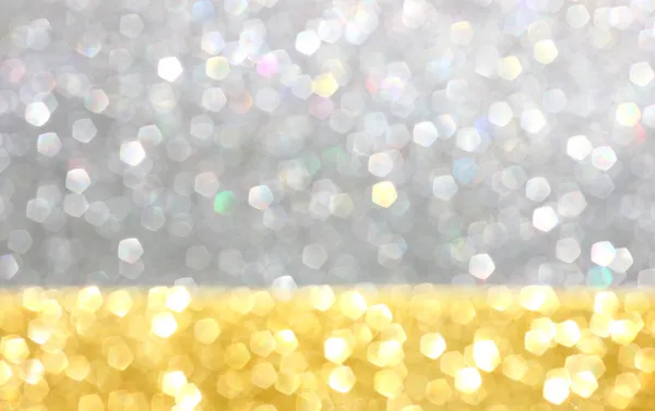 Gold and silver defocused glitter lights background. abstract bokeh.