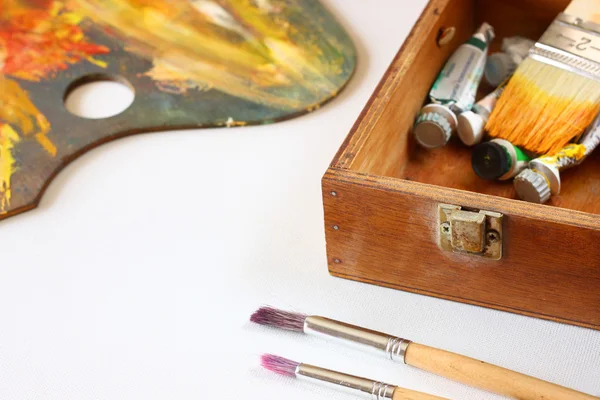 Paleta de arte de madeira e tintas sobre tela — Fotografia de Stock