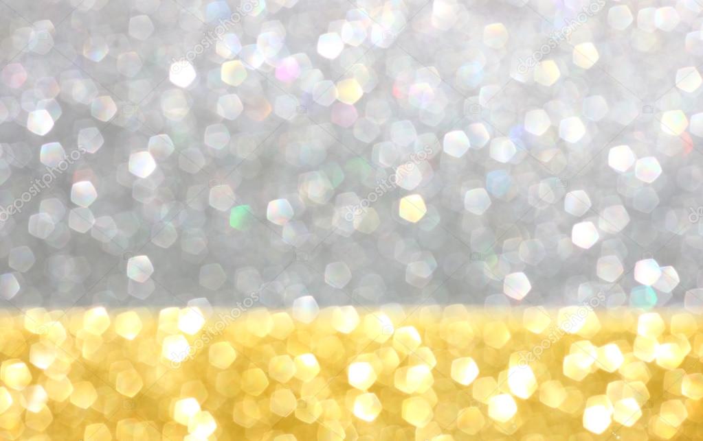 Gold and silver defocused glitter lights background. abstract bokeh.