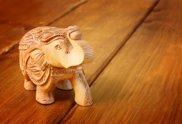 Statuette elephant on wooden table — Stock Photo, Image