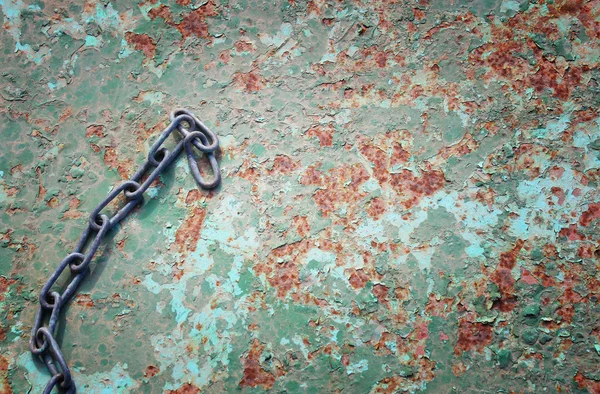 Rusty chain on rusty metal background