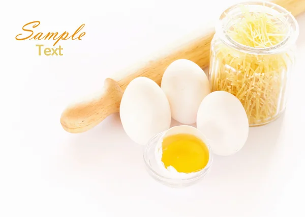 Eggs and rolling pin over white background — Stock Photo, Image