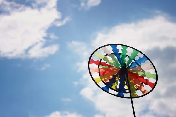 Pinwheel on blue sky with white clouds — Stock Photo, Image