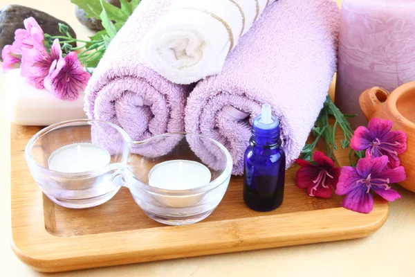 Spa and wellness setting with natural soap, candles and towel — Stock Photo, Image