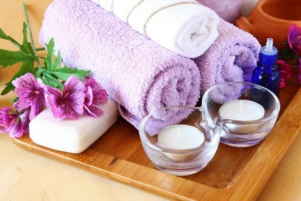 Spa and wellness setting with natural soap, candles and towel — Stock Photo, Image