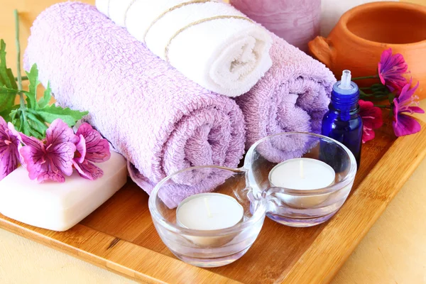 Spa and wellness setting with natural soap, candles and towel — Stock Photo, Image