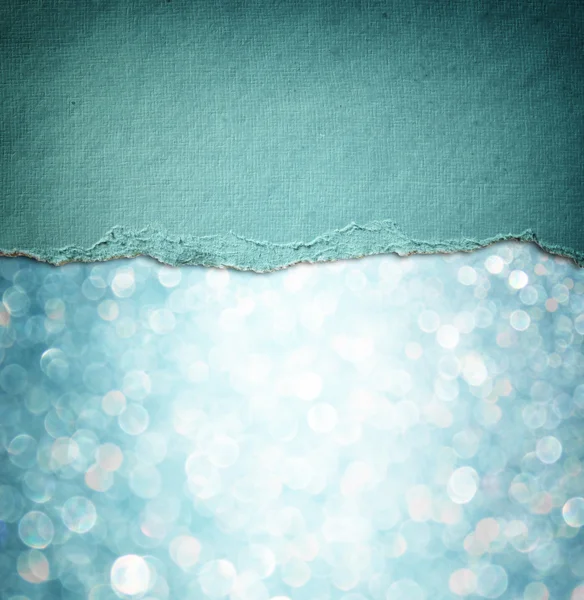 Blue glitter background and blue vintage torn paper .