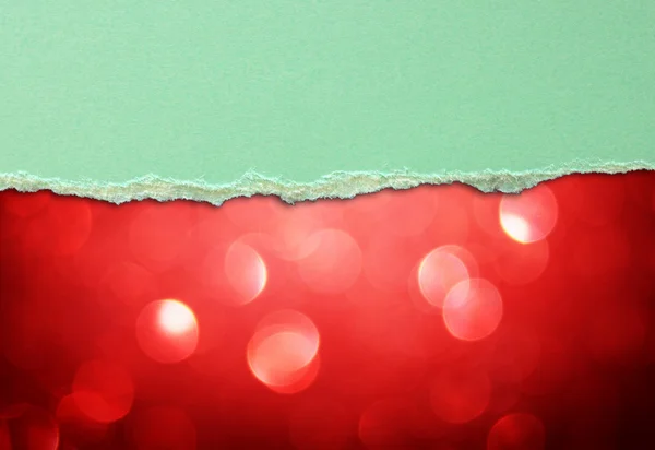 Red bokeh lights and green torn paper — Stock Photo, Image