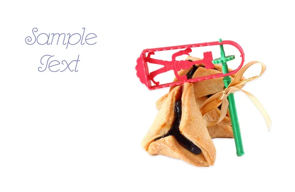 Hamantaschen cookies or hamans ears and Noisemaker for Purim celebration. isolated — Stock Photo, Image