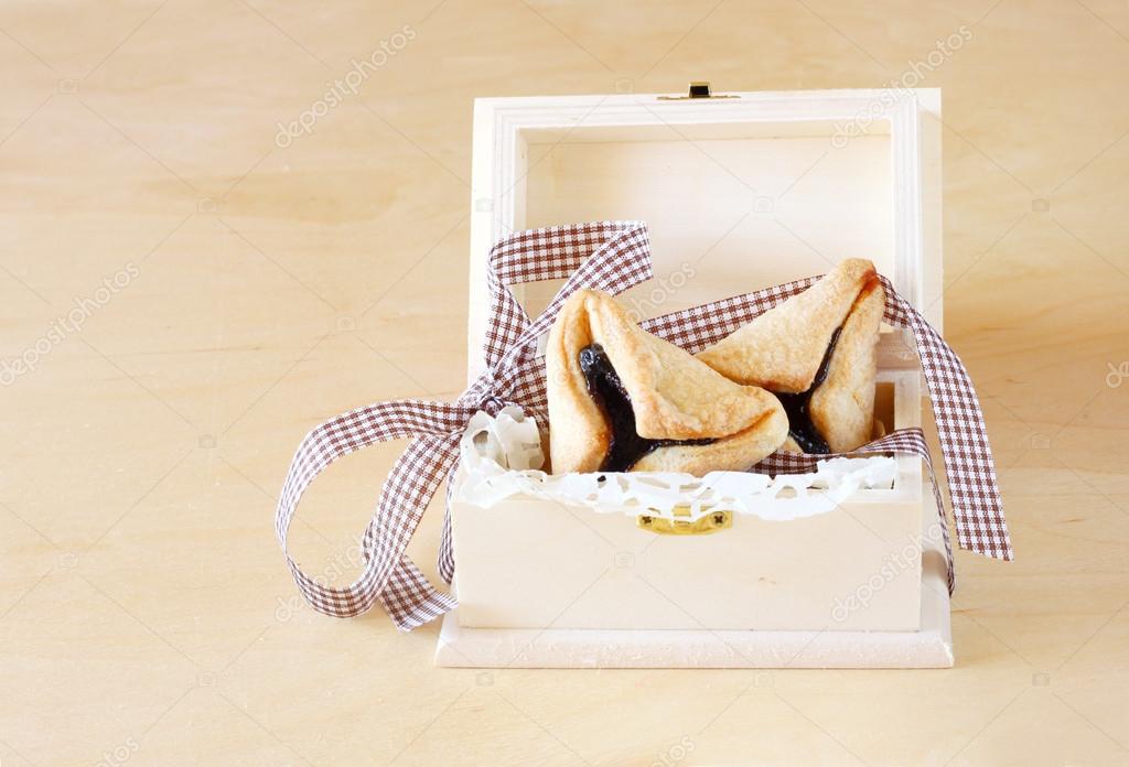 Hamantaschen cookies or hamans ears for Purim celebration in wooden box.