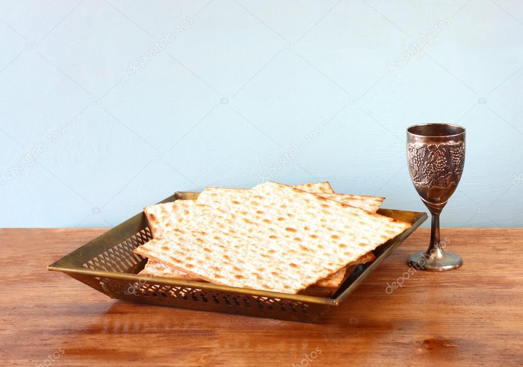 Passover background  wine and matzoh  jewish passover bread  over wooden background