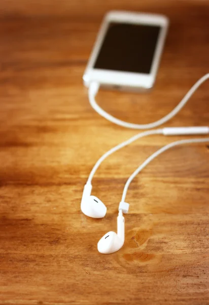 Earphones attached to smartphone. — Stock Photo, Image