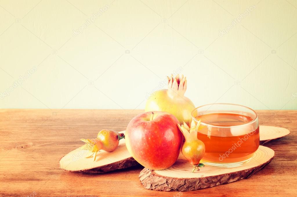 Apple honey and pomegranate over wooden table.