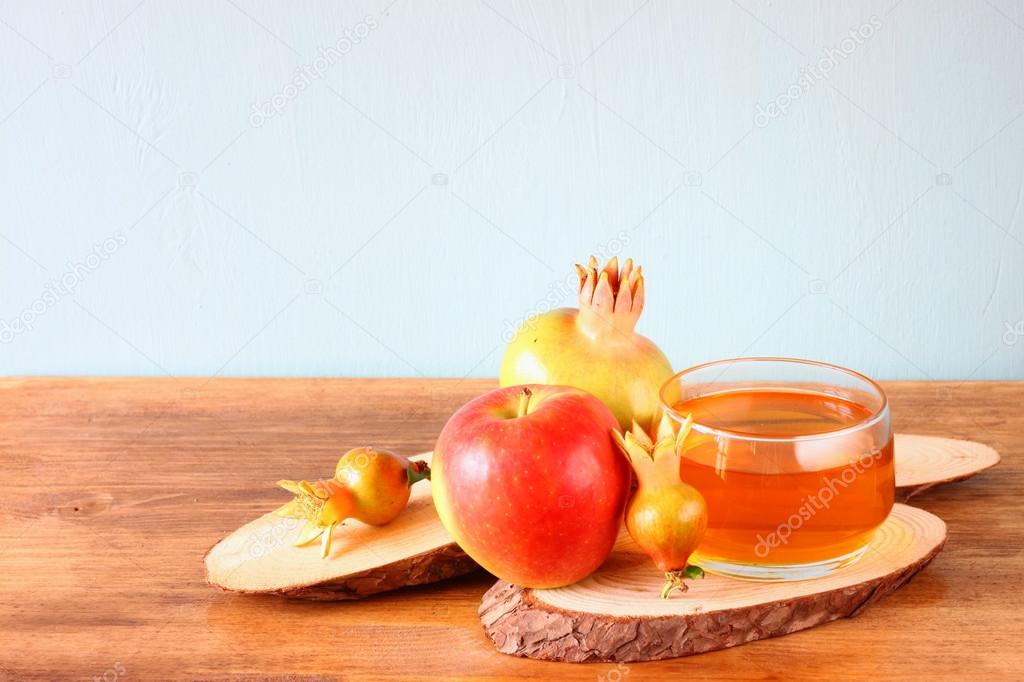 Apple honey and pomegranate over wooden table.