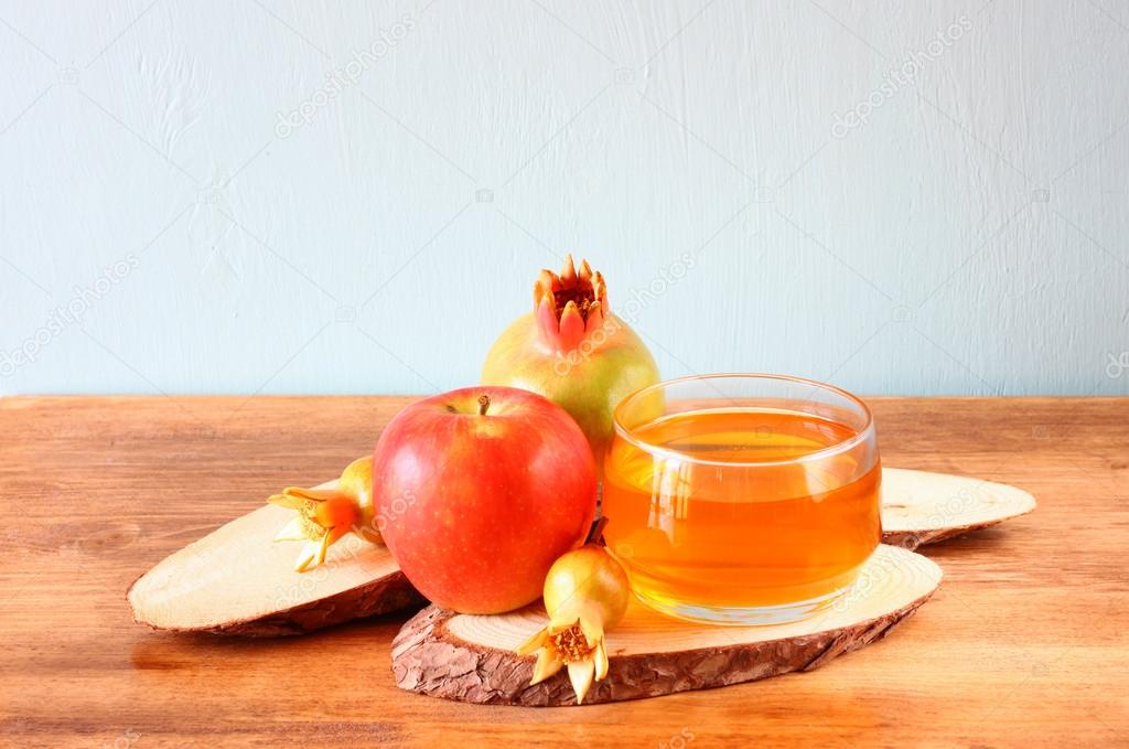 Apple honey and pomegranate over wooden table.