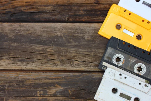 Cassette tapes over wooden table. top view. — Stock Photo, Image