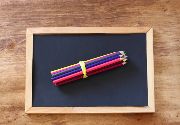Top view of blackboard , stack of pencils — Stock Photo, Image
